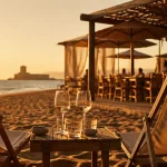 Restaurant manovi cap d agde, transats et terrasse Manovi Plage face au Fort Brescou à l’heure dorée